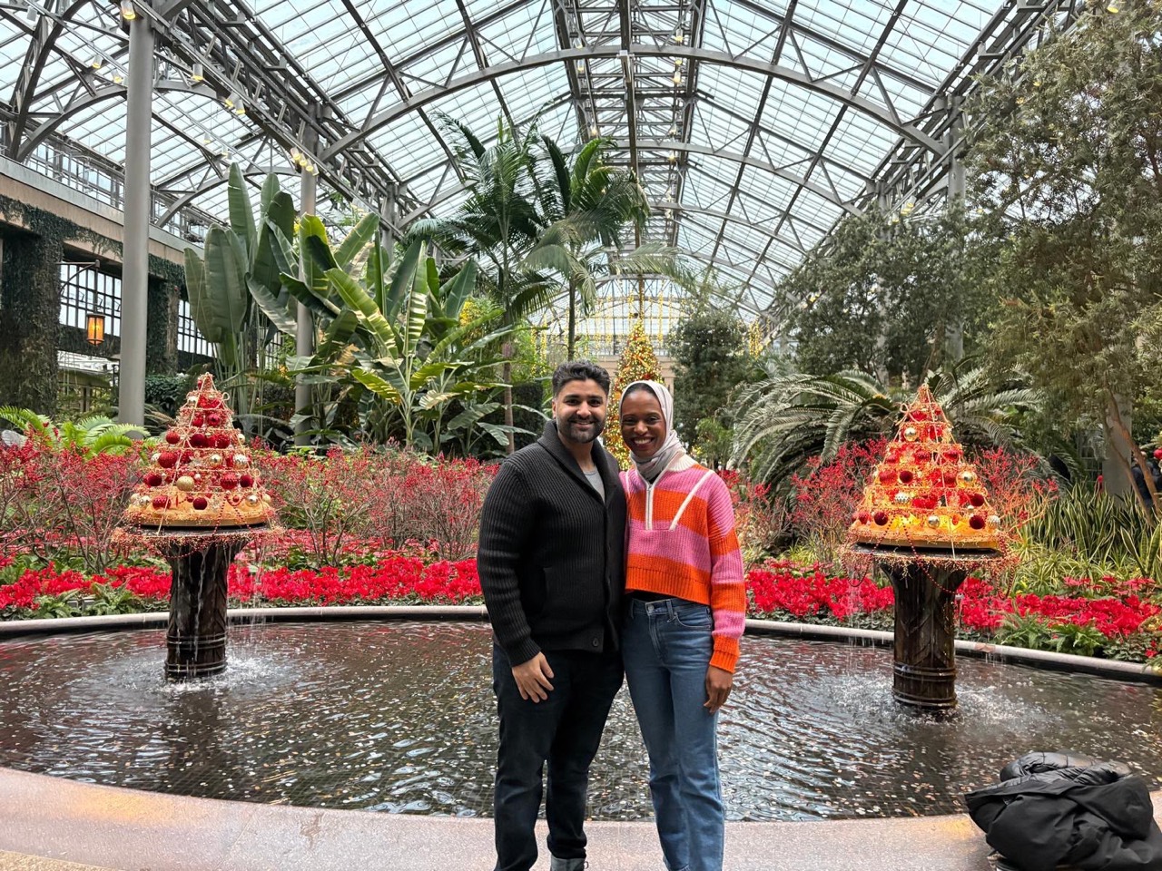 Amal and Usman together in a glass-roofed garden