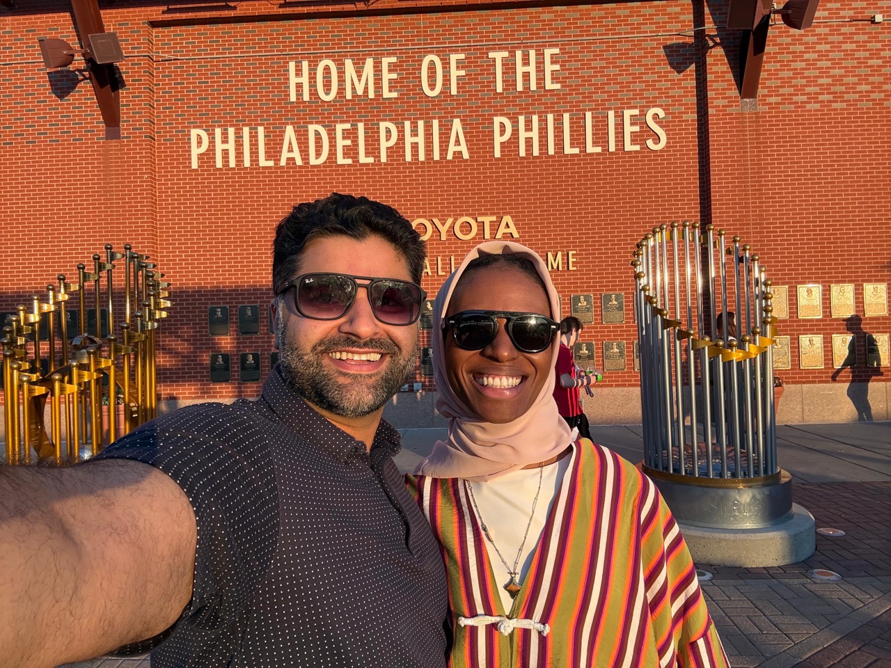 Amal and Usman smiling at the Philadelphia Phillies ballpark